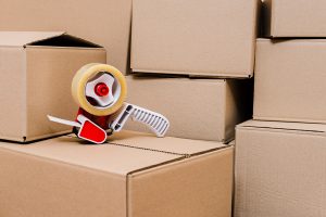 Packing tape dispenser and boxes - 7 Reasons to hire a moving company - JR cleaning and removals - Sheffield, Rotherham and rest of South Yorkshire