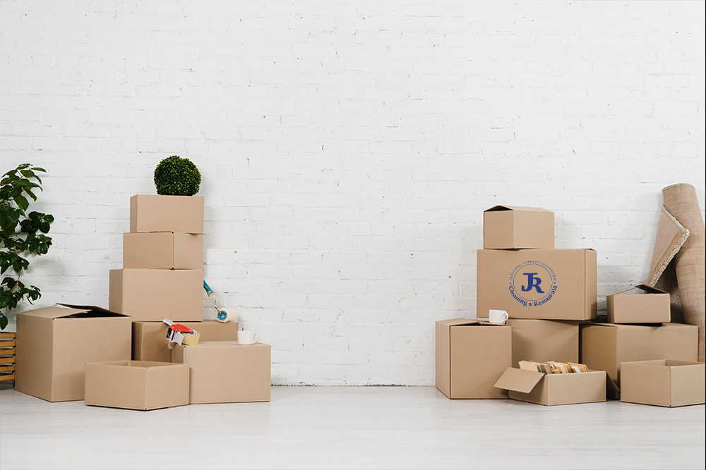 JR moving boxes against wall for Best Removals Company Near Me blog